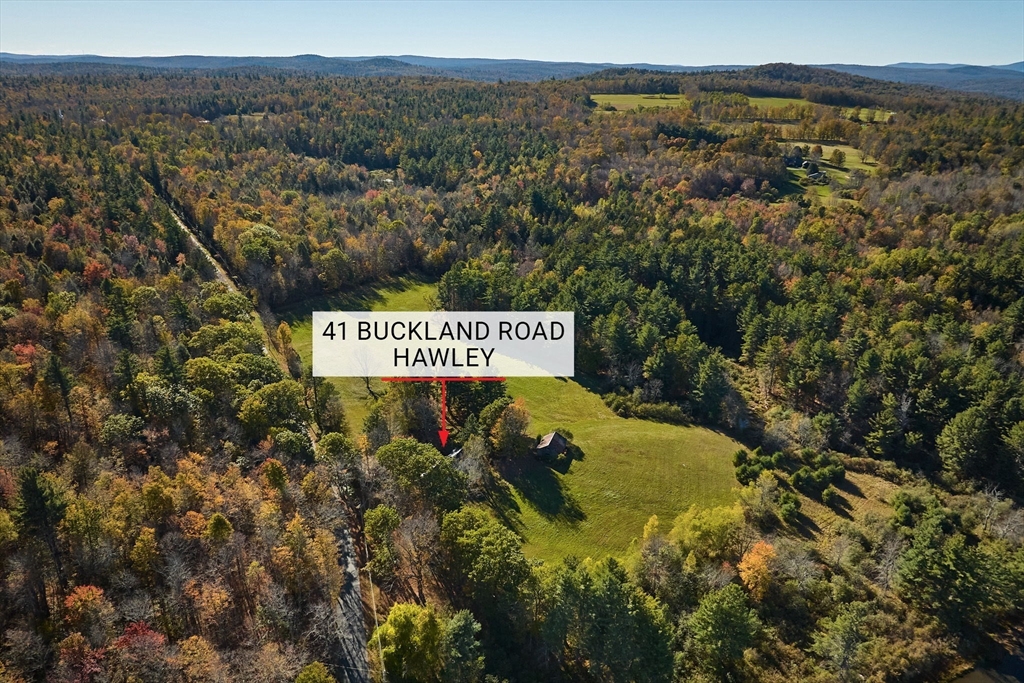 41 Buckland Road Hawley, MA 01339 - Photo 40 of 42 a sign that is sitting on a beach