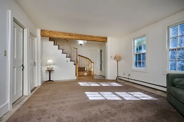 a view of a livingroom with an empty space and a fireplace