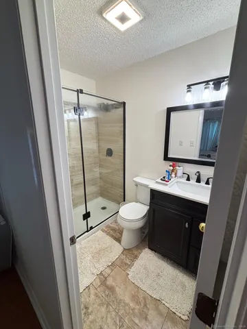 a bathroom with a toilet sink and shower