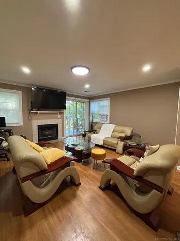 a living room with furniture a fireplace and a flat screen tv