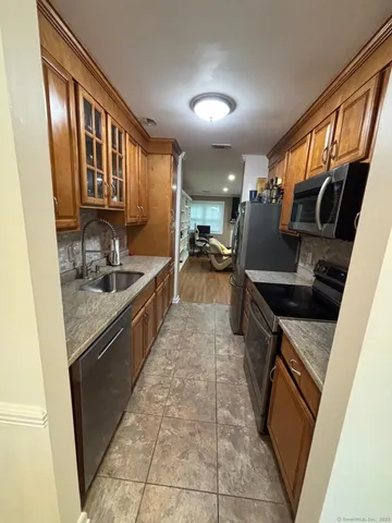a kitchen with granite countertop a stove and a sink