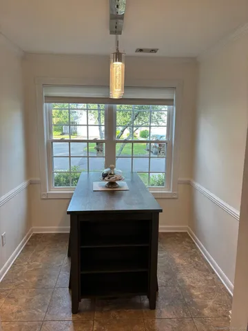 a view of hall way with furniture and window