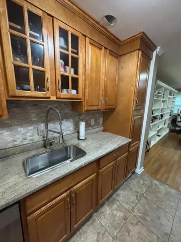 a kitchen with stainless steel appliances granite countertop a sink and cabinets