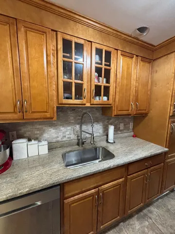 a kitchen with stainless steel appliances granite countertop a sink and cabinets