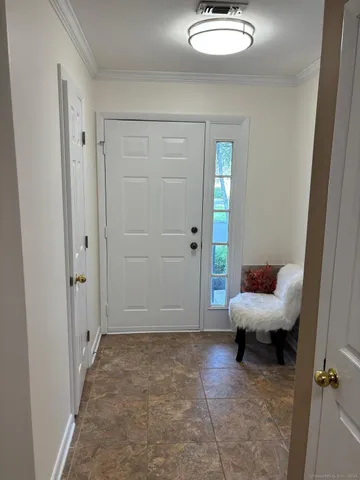 a living room with furniture and a chair