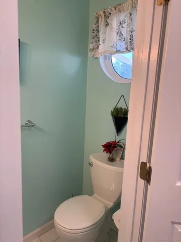 a white toilet sitting next to a small sink