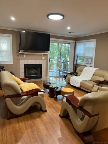 a living room with furniture a fireplace and a flat screen tv