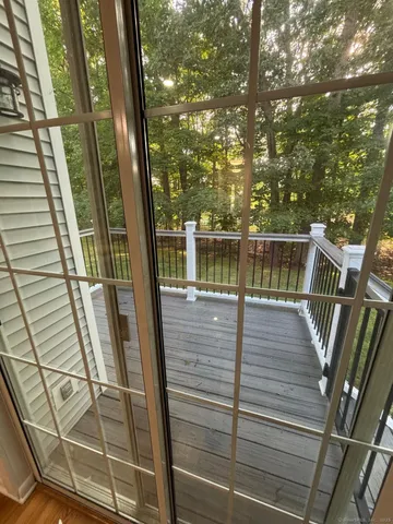 a view of balcony with wooden floor and fence and floor