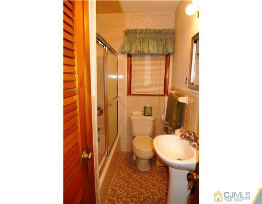 101 Stelton Road Piscataway, NJ 08854 - Photo 11 of 13 a bathroom with a toilet sink and shower