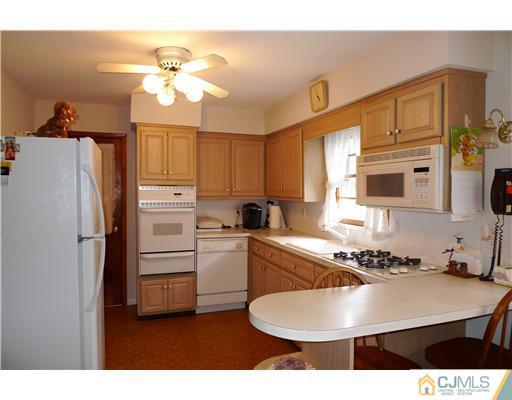 101 Stelton Road Piscataway, NJ 08854 - Photo 7 of 13 a kitchen with stainless steel appliances kitchen island a table and chairs