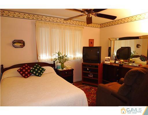 101 Stelton Road Piscataway, NJ 08854 - Photo 8 of 13 a bedroom with a bed and a television