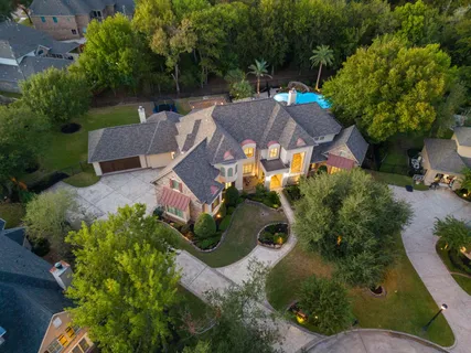 an aerial view of a house with yard swimming pool and outdoor seating