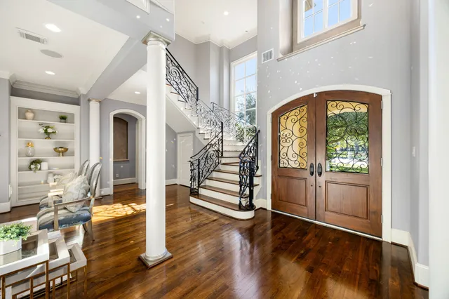 a living room with furniture a fireplace and a chandelier