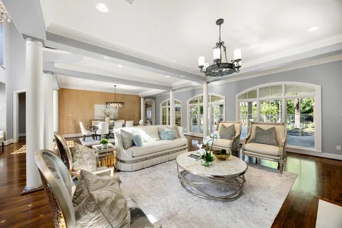 a view of a workspace with furniture and wooden floor