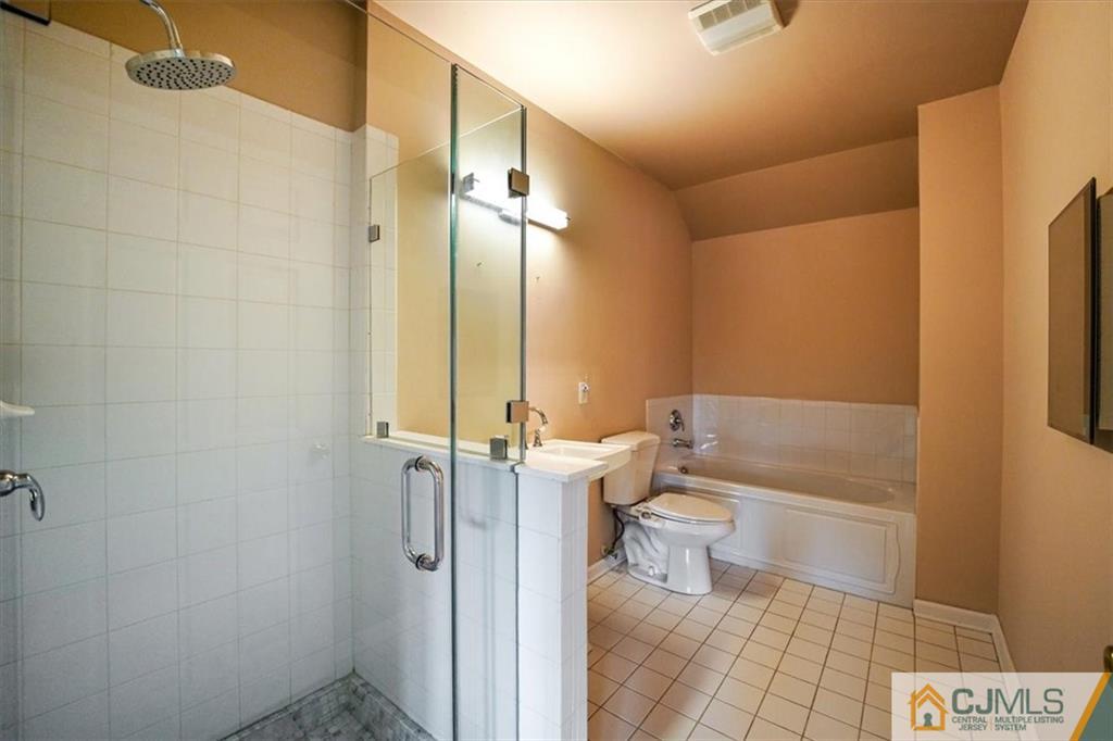 368 Rector Street, Unit 511 Perth Amboy, NJ 08861 - Photo 14 of 16 a bathroom with a toilet a sink and shower