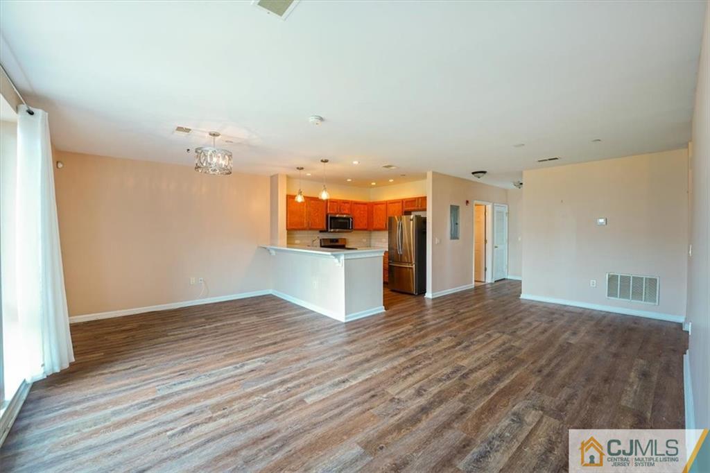 368 Rector Street, Unit 511 Perth Amboy, NJ 08861 - Photo 4 of 16 a view of a kitchen with a sink and wooden floor