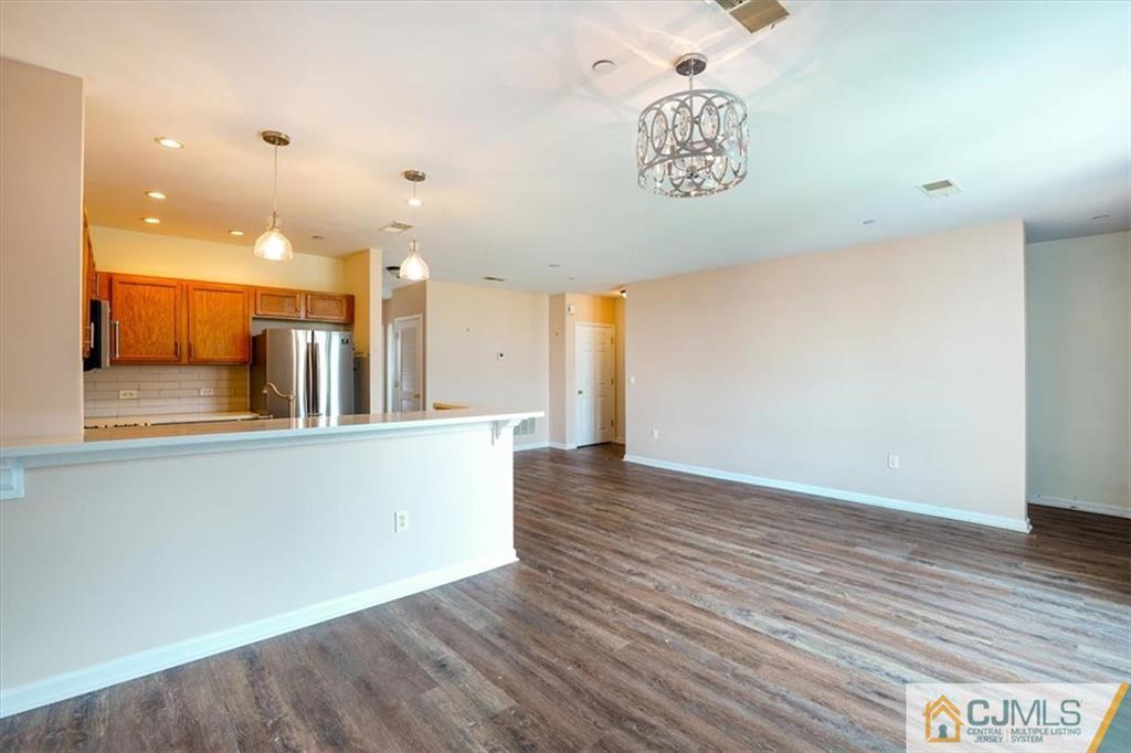 368 Rector Street, Unit 511 Perth Amboy, NJ 08861 - Photo 5 of 16 wooden floor in an empty room with a window