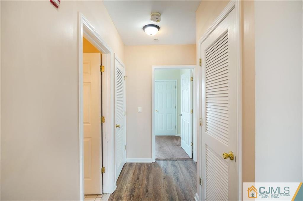 368 Rector Street, Unit 511 Perth Amboy, NJ 08861 - Photo 7 of 16 a view of a hallway with wooden floor and closet