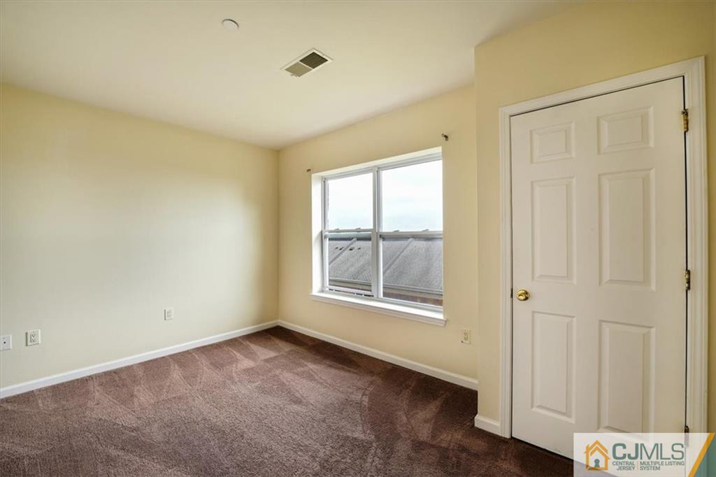 368 Rector Street, Unit 511 Perth Amboy, NJ 08861 - Photo 9 of 16 an empty room with windows