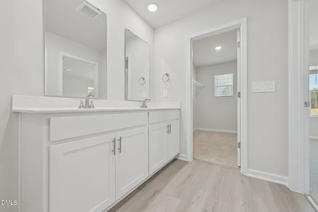 a bathroom with a sink and vanity