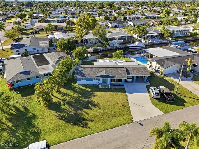 an aerial view of a swimming pool with outdoor seating