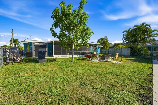 a view of a house with backyard and sitting area