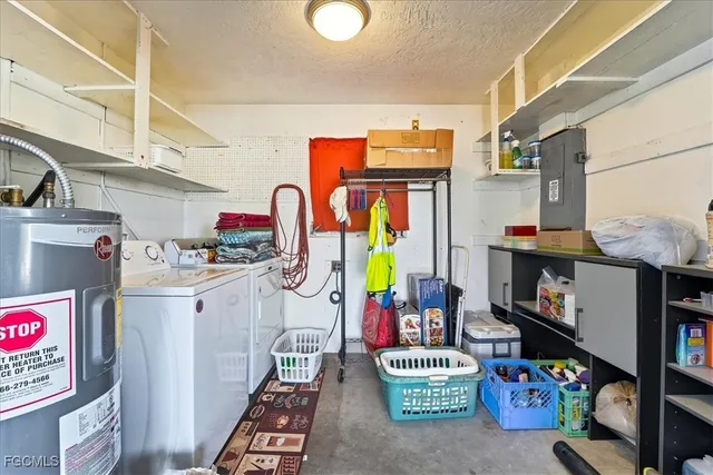 a utility room with fridge dryer and bicycles parked
