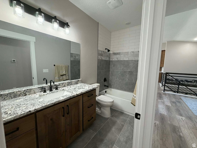 2350 North 1075 West Helper, UT 84526 - Photo 21 of 49 Bathroom featuring vanity, shower / bathtub combination, and a textured ceiling