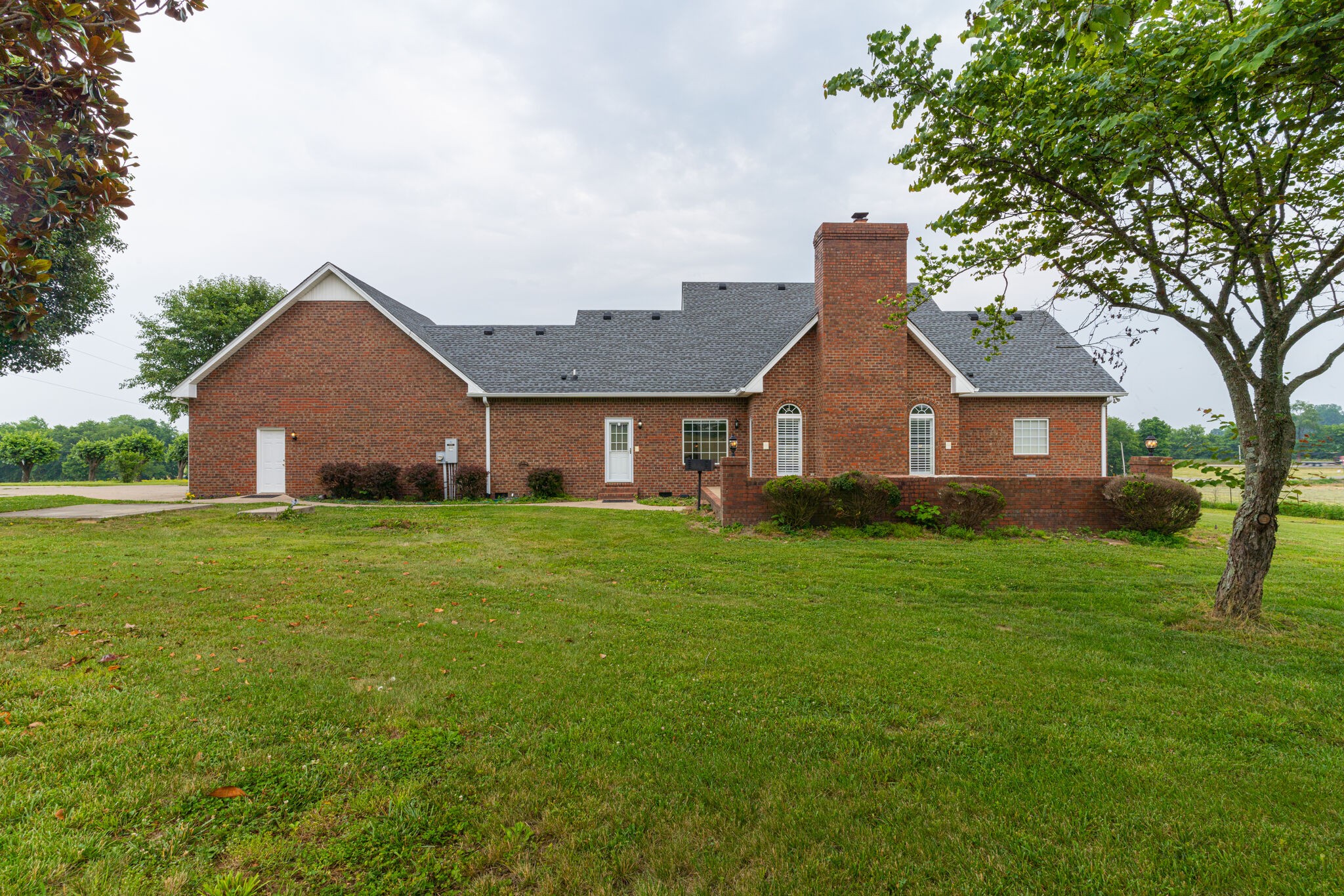 115 Rock Bridge Road Gallatin, TN 37066 - Photo 52 of 70 a front view of a house with a garden and yard