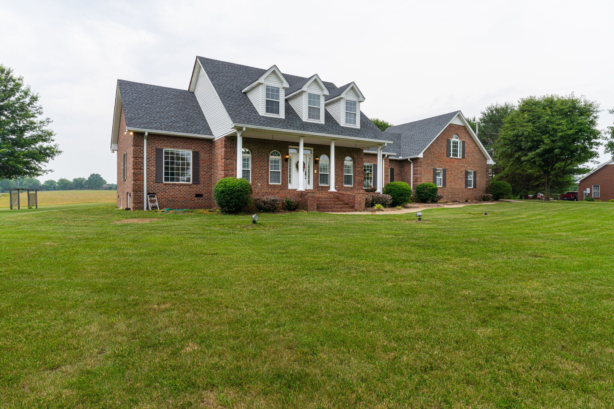 115 Rock Bridge Road Gallatin, TN 37066 - Photo 62 of 70 a front view of a house with a garden and trees