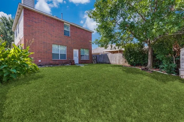 a view of a house with a yard and sitting area