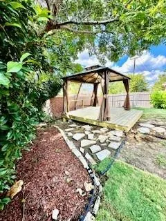 a view of a backyard with sitting area