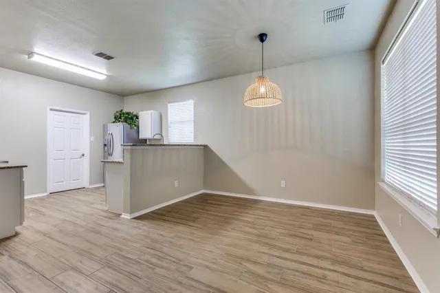 a view of a kitchen with a dishwasher cabinets and a window