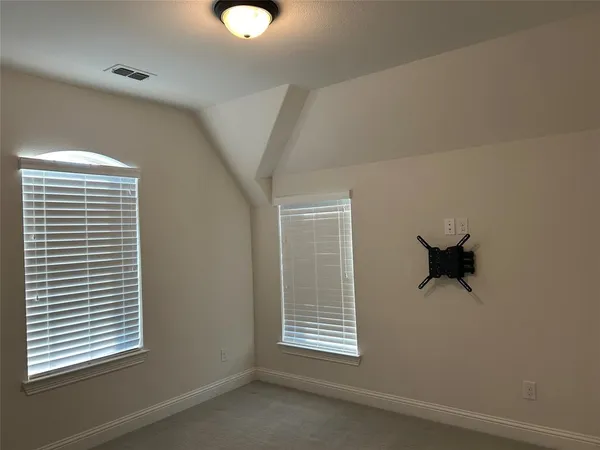 a view of a room that has a window and a ceiling fan