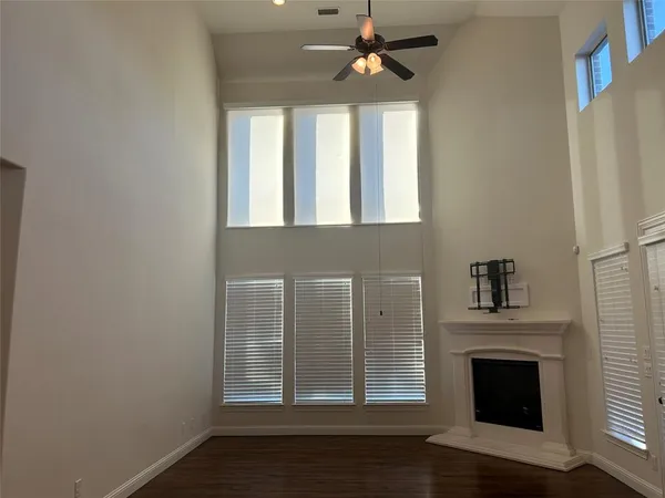 a view of an empty room with a fireplace and a window