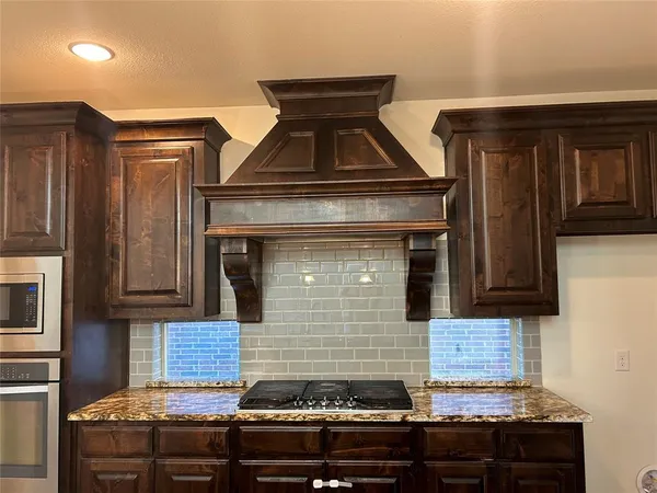 a stove top oven sitting inside of a kitchen
