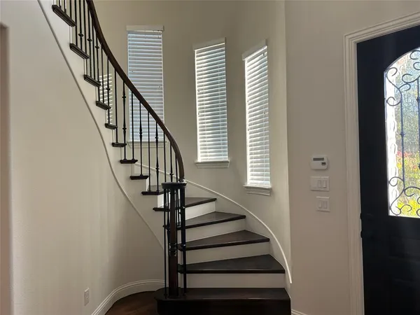 a view of entryway with wooden floor and stairs