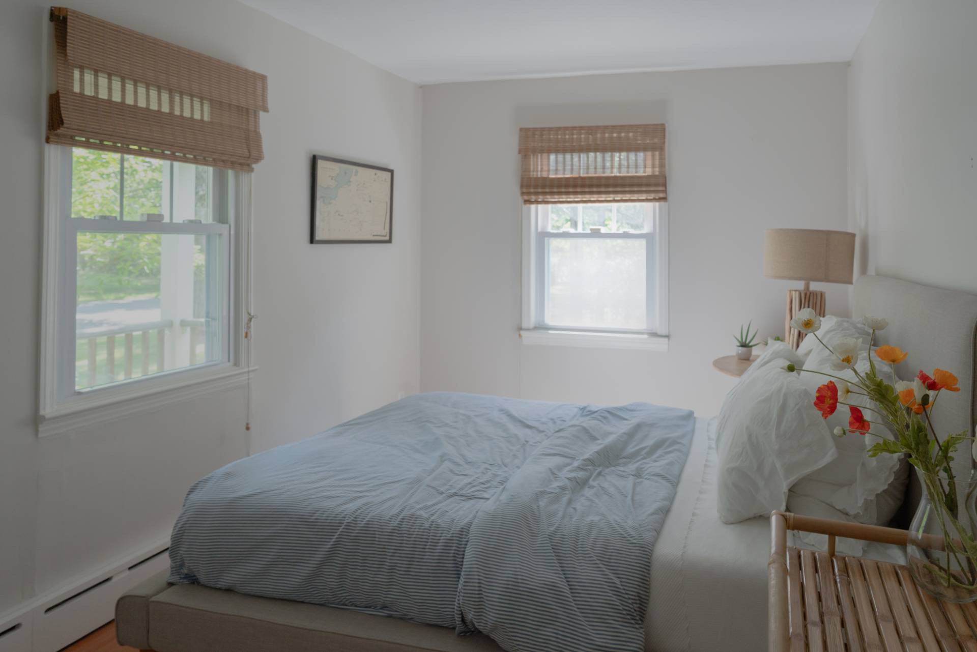32 Hallock Road East Quogue, NY 11942 - Photo 11 of 24 a bed sitting in a bedroom next to a window