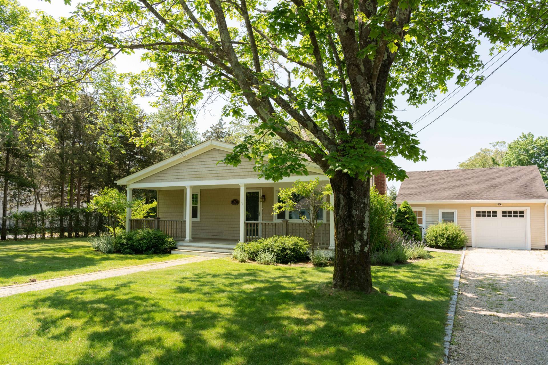 32 Hallock Road East Quogue, NY 11942 - Photo 22 of 24 a front view of a house with garden