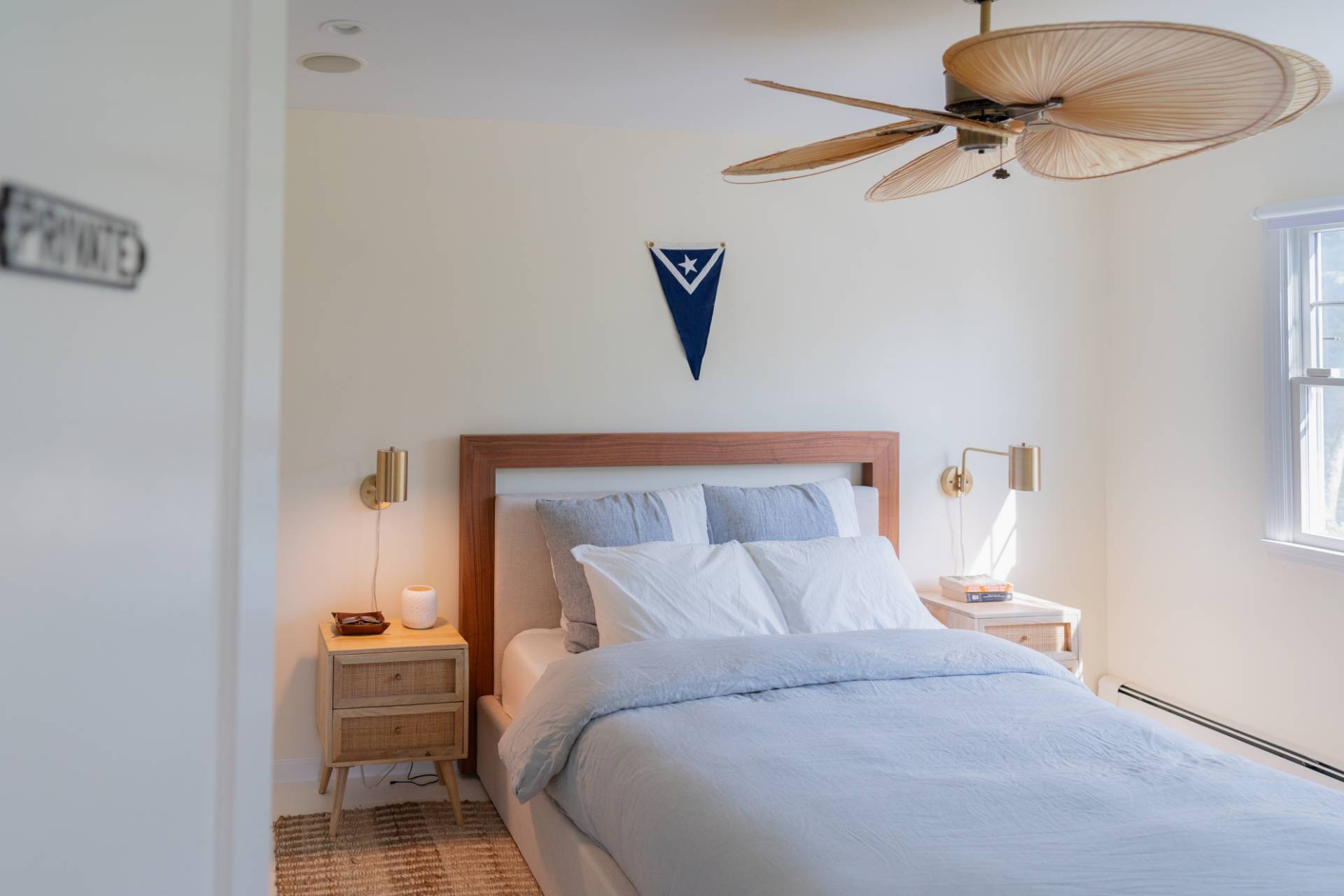 32 Hallock Road East Quogue, NY 11942 - Photo 9 of 24 a bedroom with a bed and a chandelier