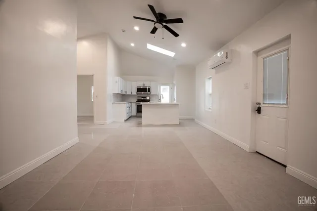 a view of a kitchen with a sink and a refrigerator