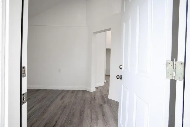a view of a hallway with wooden floor