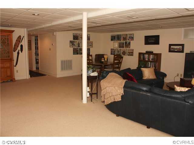 9100 River Road Henrico, VA 23229 - Photo 15 of 24 a living room with furniture a flat screen tv and a table