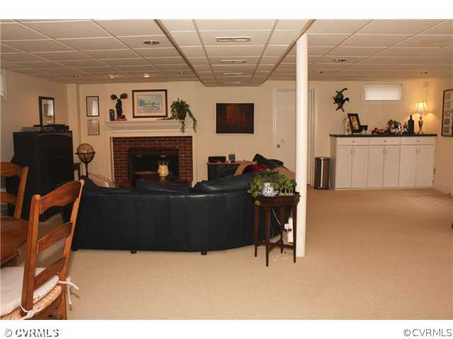 9100 River Road Henrico, VA 23229 - Photo 16 of 24 a living room with furniture a fireplace and a flat screen tv