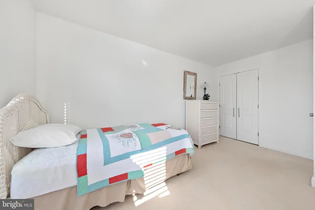 a utility room with baby crib furniture and a couch