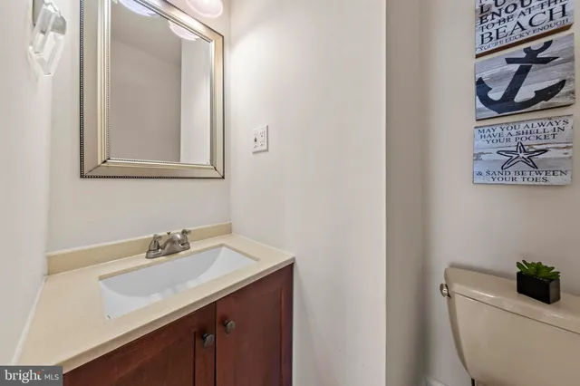 a bathroom with a sink a toilet and mirror