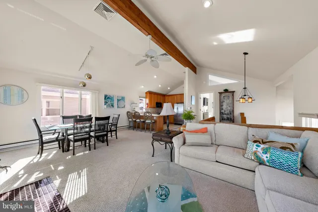 a living room with furniture and a dining table