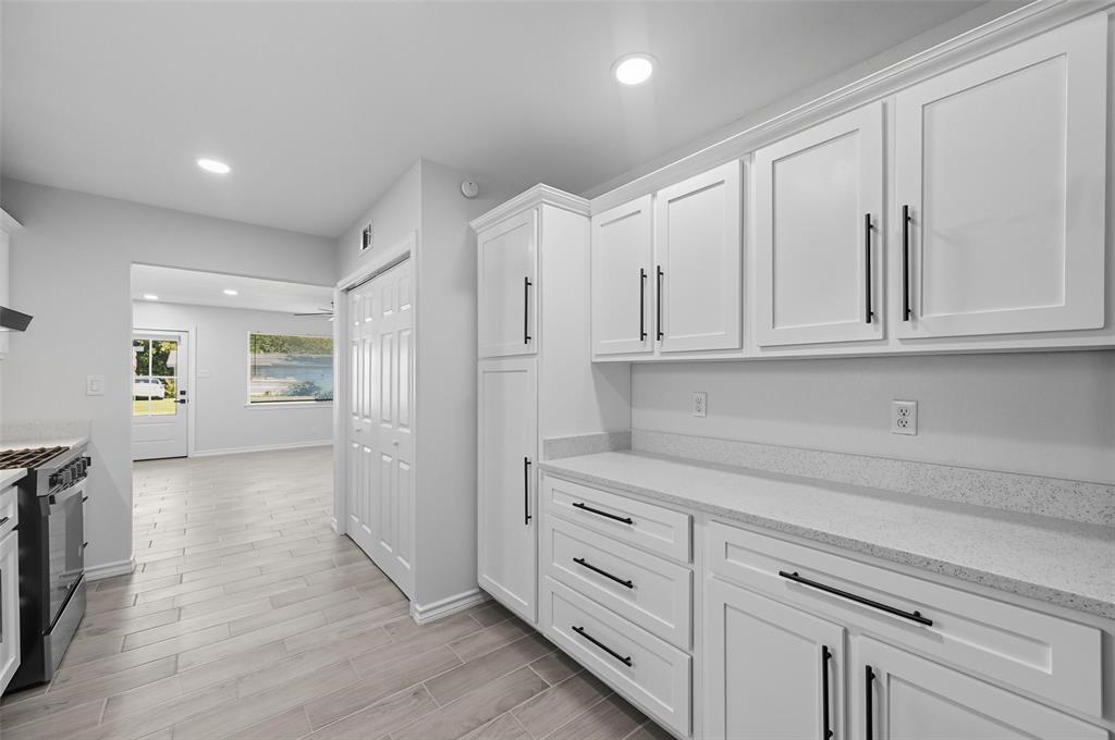a view of a kitchen with white cabinets