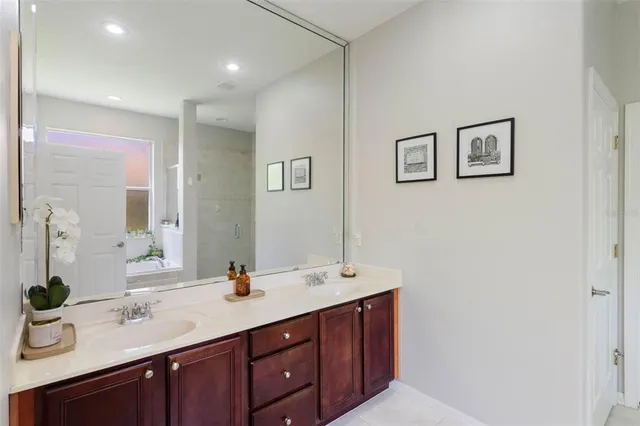 a spacious bathroom with a double vanity sink and a mirror