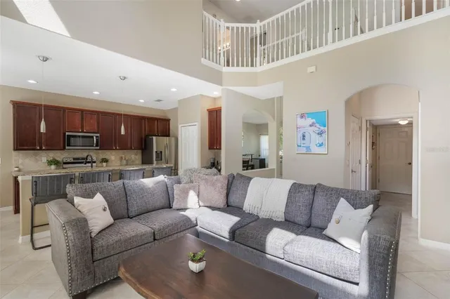 a living room with furniture and kitchen view